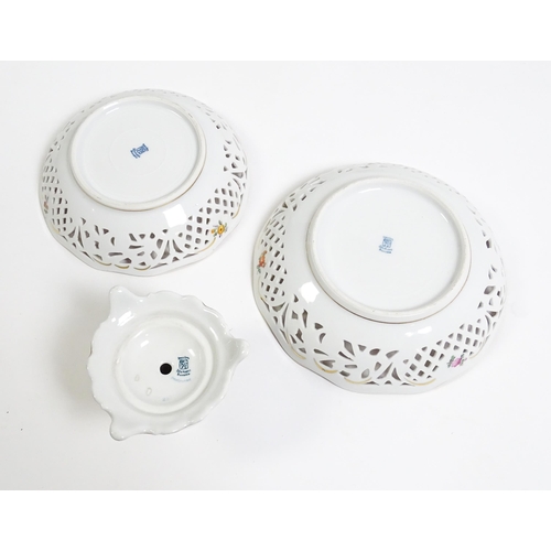 91 - A German part dessert service with pierced borders and floral decoration, to include plates, basket,... 