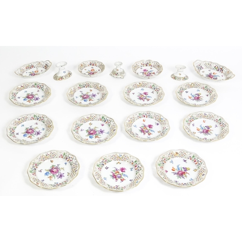 91 - A German part dessert service with pierced borders and floral decoration, to include plates, basket,... 