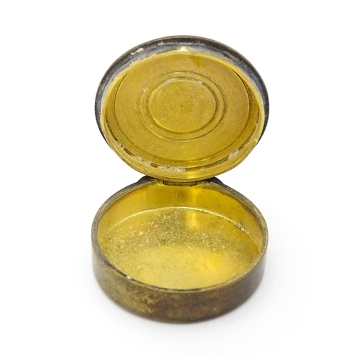 306 - A Continental silver gilt pill / patch box with guilloche enamel detail to lid. Indistinctly marked,... 