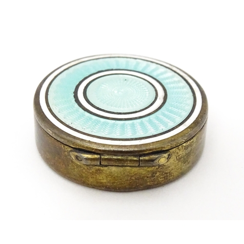 306 - A Continental silver gilt pill / patch box with guilloche enamel detail to lid. Indistinctly marked,... 