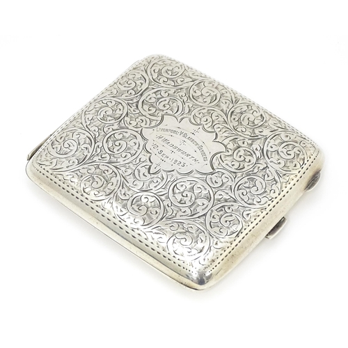 517 - A silver cigarette case with acanthus scroll decoration and gilded interior. Hallmarked Birmingham 1... 