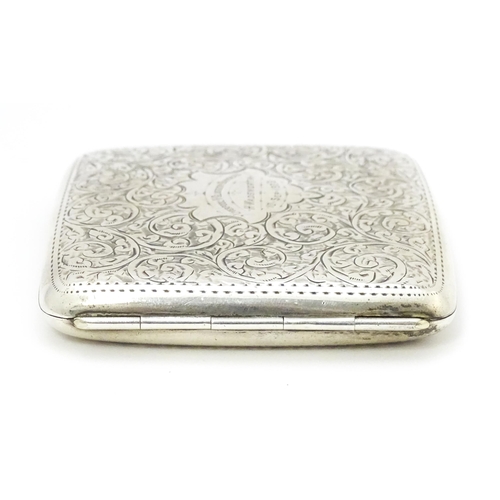 517 - A silver cigarette case with acanthus scroll decoration and gilded interior. Hallmarked Birmingham 1... 