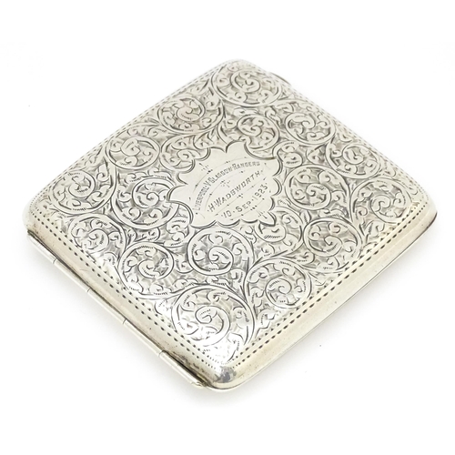 517 - A silver cigarette case with acanthus scroll decoration and gilded interior. Hallmarked Birmingham 1... 