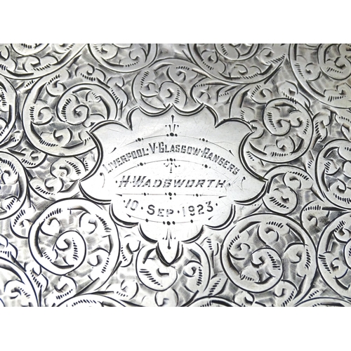 517 - A silver cigarette case with acanthus scroll decoration and gilded interior. Hallmarked Birmingham 1... 