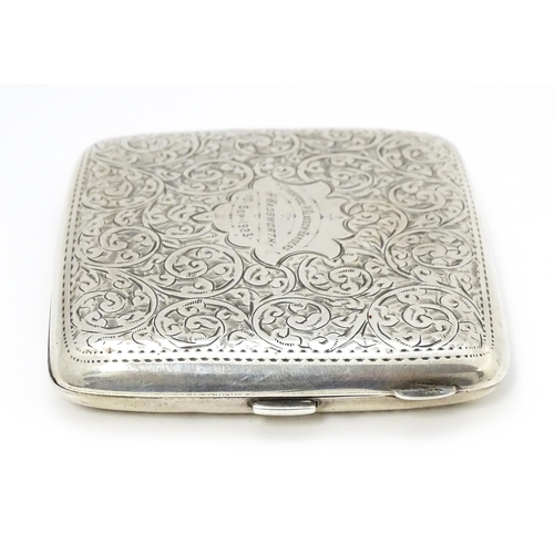 517 - A silver cigarette case with acanthus scroll decoration and gilded interior. Hallmarked Birmingham 1... 