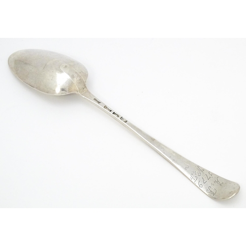 527 - A Geo III silver table spoon hallmarked London 1780, maker WC. Approx. 8 1/2