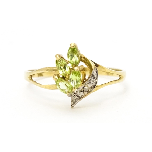 606 - A 9ct gold ring set with peridot and diamonds. Ring size approx. O