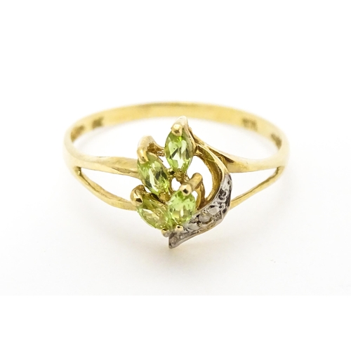 606 - A 9ct gold ring set with peridot and diamonds. Ring size approx. O