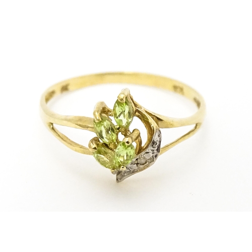 606 - A 9ct gold ring set with peridot and diamonds. Ring size approx. O