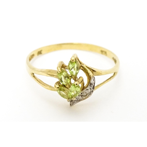 606 - A 9ct gold ring set with peridot and diamonds. Ring size approx. O