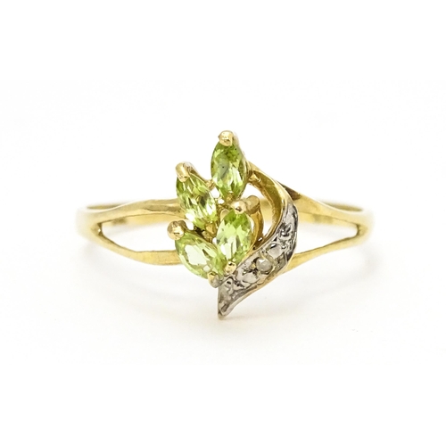 606 - A 9ct gold ring set with peridot and diamonds. Ring size approx. O