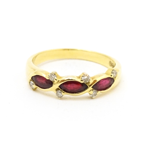 618 - An 18ct gold ring set with three rubies and six diamonds. Ring size approx. P 1/2