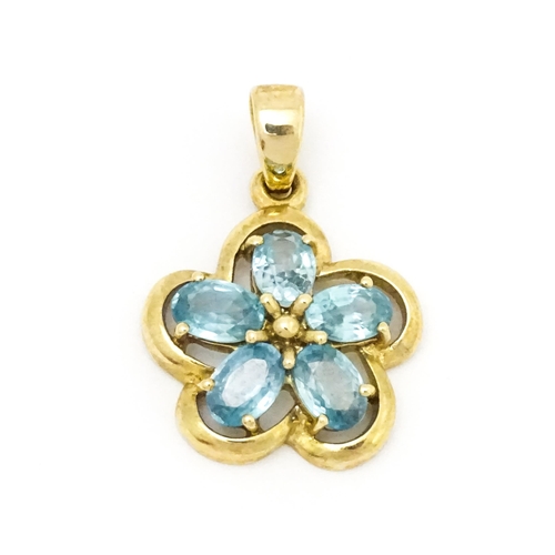 707 - A 9ct gold pendant set with zircons in a floral setting. Approx. 11