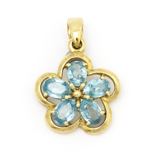 707 - A 9ct gold pendant set with zircons in a floral setting. Approx. 11