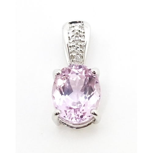 715 - A 9ct white gold pendant set with amethyst and diamonds. Approx. 3/4