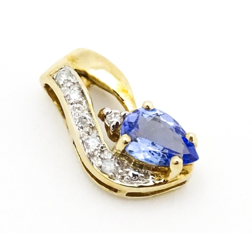 717 - A 9ct gold pendant set with tanzanite and diamonds. Approx. 1/2