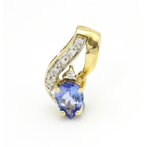 717 - A 9ct gold pendant set with tanzanite and diamonds. Approx. 1/2