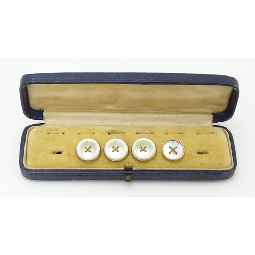 753 - A stud box containing 4 gilt and mother of pearl studs (3+1)