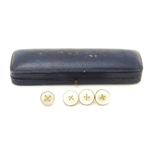 753 - A stud box containing 4 gilt and mother of pearl studs (3+1)