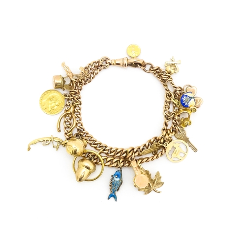 764 - A 9ct gold twin chain charm bracelet set with various 9ct gold and yellow metal charms to include a ... 