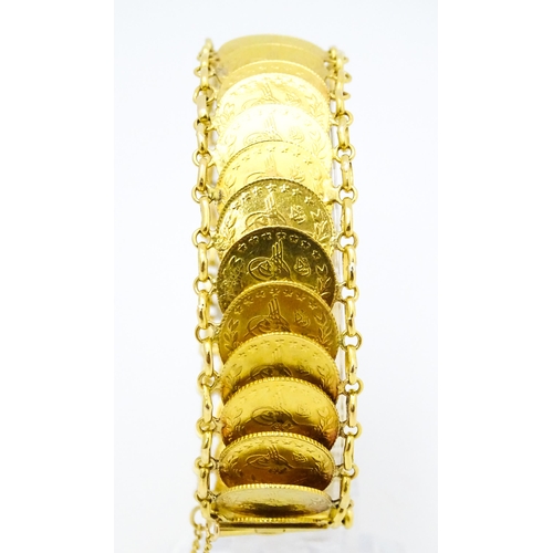 765 - A gold bracelet set with approximately 28 Ottoman coins. Approx. 7