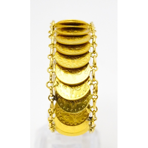 765 - A gold bracelet set with approximately 28 Ottoman coins. Approx. 7