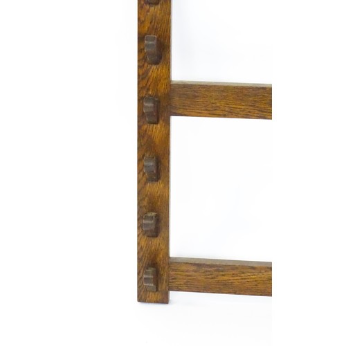 1462 - A 20thC oak whip rack with six shaped hooks. 21