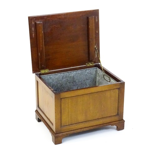 1502 - An early / mid 20thC mahogany log bin / coal box with a hinged lid, metal lined interior and raised ... 