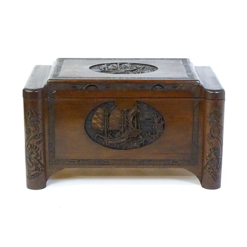 1520 - A 20thC oriental camphor wood trunk, with a carved front and sides, the carving depicting sail ships... 