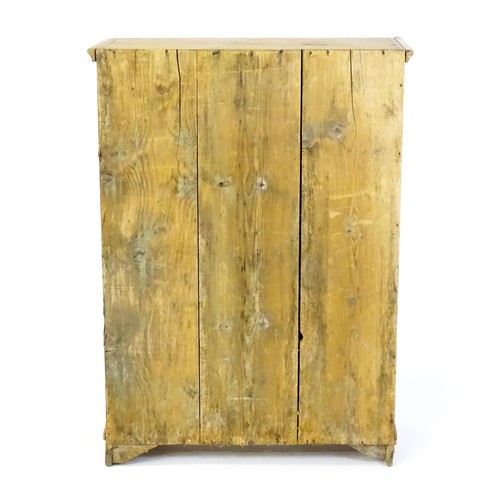 1531 - A 19thC pine cupboard with a moulded top above a single panelled door and raised on four bracket fee... 