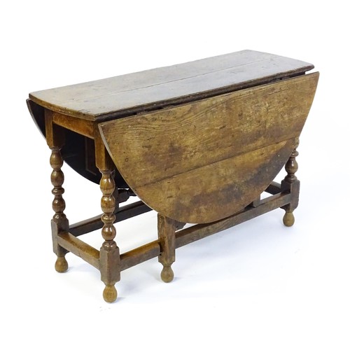 1540 - An early 18thC oak drop leaf table of large proportions, the table having two demi lune leaves and r... 