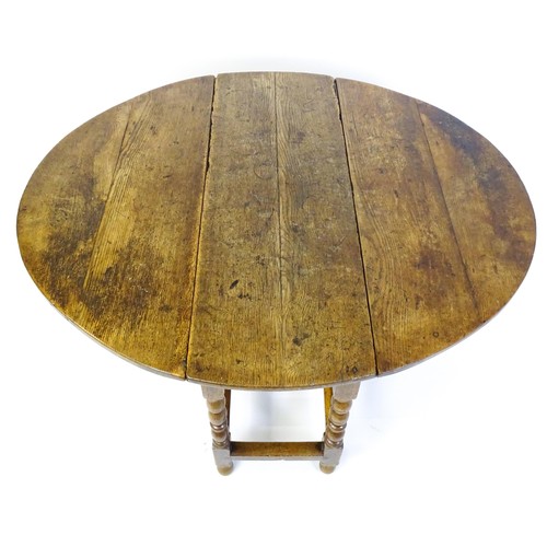 1540 - An early 18thC oak drop leaf table of large proportions, the table having two demi lune leaves and r... 