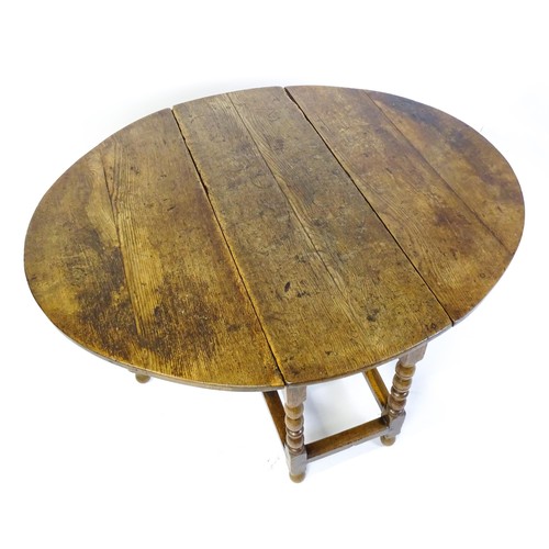 1540 - An early 18thC oak drop leaf table of large proportions, the table having two demi lune leaves and r... 