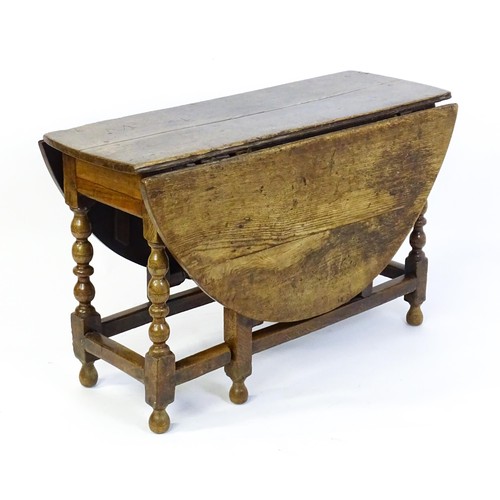 1540 - An early 18thC oak drop leaf table of large proportions, the table having two demi lune leaves and r... 