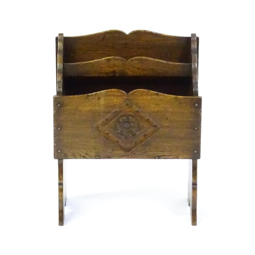 1551 - An early / mid 20thC oak magazine rack with a carved rosette within a carved lozenge to the front. 1... 