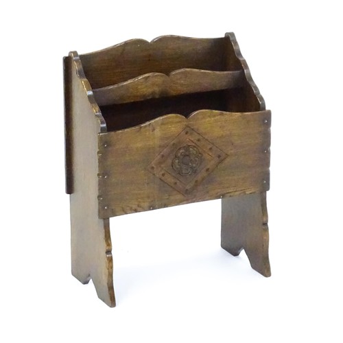 1551 - An early / mid 20thC oak magazine rack with a carved rosette within a carved lozenge to the front. 1... 