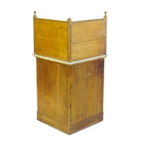 1557 - A late 19thC oak corner washstand, with a twelve tile splashback above a marble top and panelled cup... 