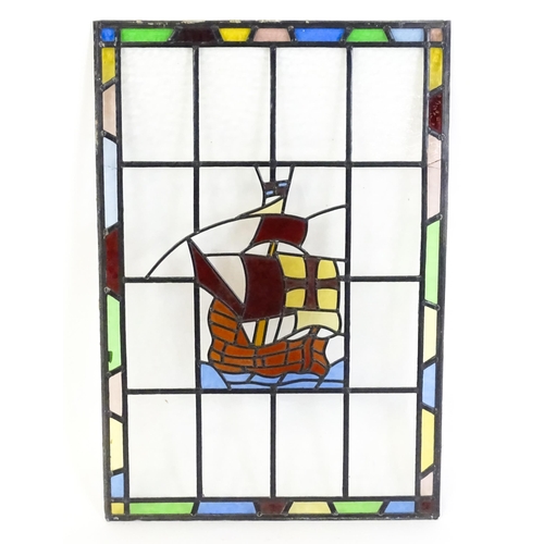 1265 - A 20thC stained glass panel depicting a sailing ship with flag. Approx. 33