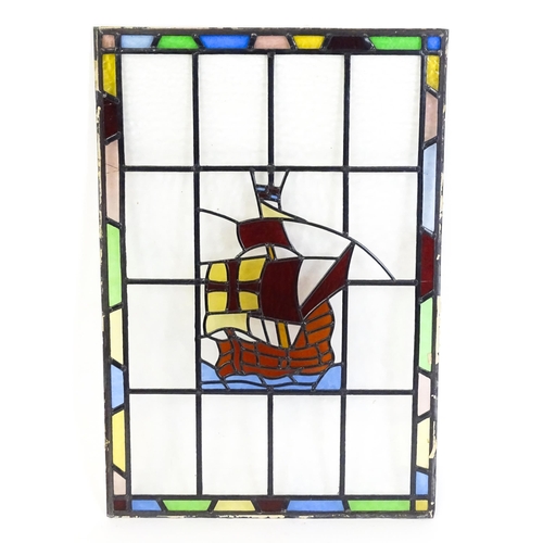 1265 - A 20thC stained glass panel depicting a sailing ship with flag. Approx. 33