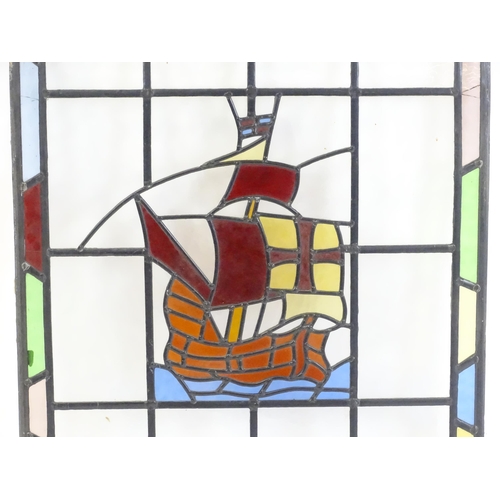 1265 - A 20thC stained glass panel depicting a sailing ship with flag. Approx. 33