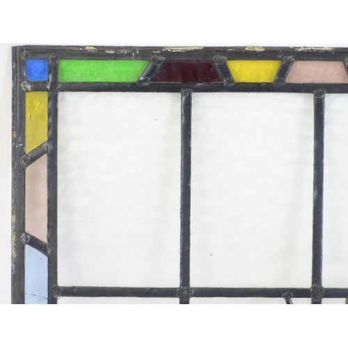 1265 - A 20thC stained glass panel depicting a sailing ship with flag. Approx. 33