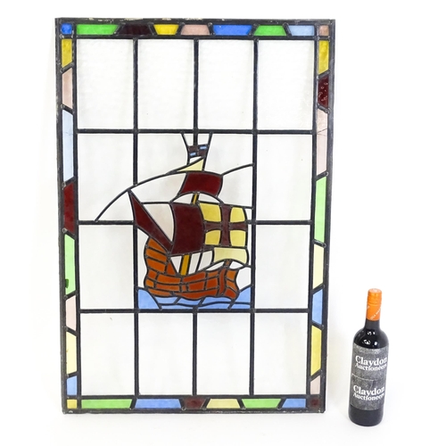 1265 - A 20thC stained glass panel depicting a sailing ship with flag. Approx. 33