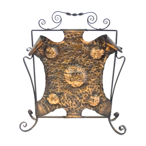 1303 - An Art Nouveau wrought iron and embossed copper fire screen, approx 22