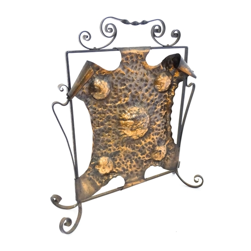 1303 - An Art Nouveau wrought iron and embossed copper fire screen, approx 22