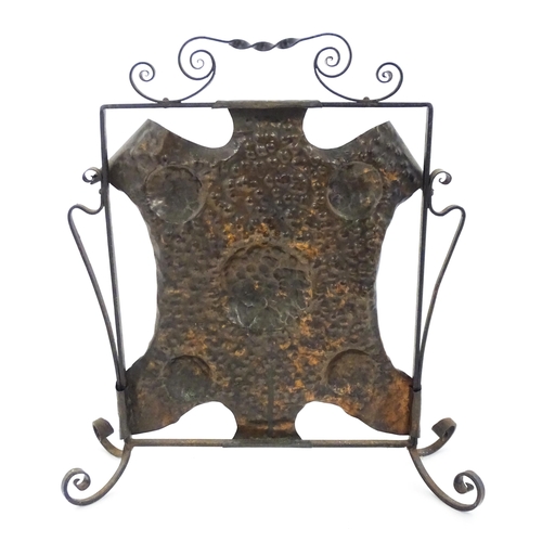 1303 - An Art Nouveau wrought iron and embossed copper fire screen, approx 22