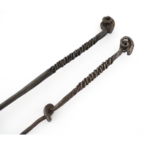 1303A - Two blacksmith made fire tools in the manner of Aaron Petersen with twist handle and rams head finia... 