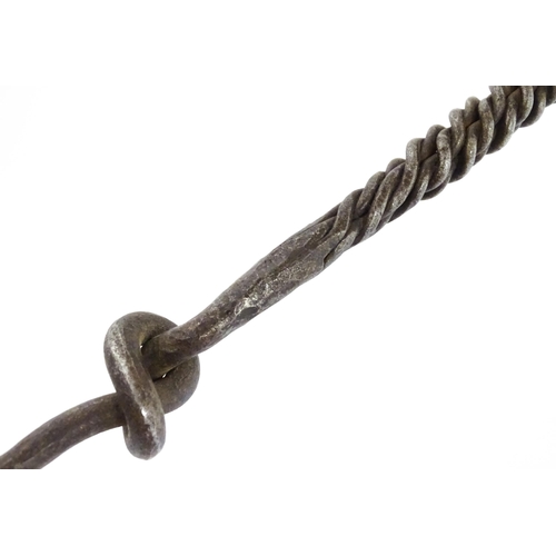 1303A - Two blacksmith made fire tools in the manner of Aaron Petersen with twist handle and rams head finia... 