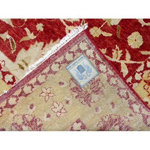 1335 - Carpet / Rug : A red ground rug with cream beige borders and floral and foliate detail. ' Palazzo Qu... 