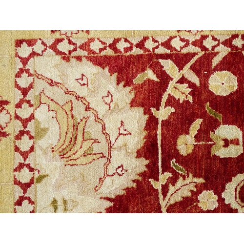 1335 - Carpet / Rug : A red ground rug with cream beige borders and floral and foliate detail. ' Palazzo Qu... 