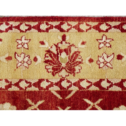 1335 - Carpet / Rug : A red ground rug with cream beige borders and floral and foliate detail. ' Palazzo Qu... 